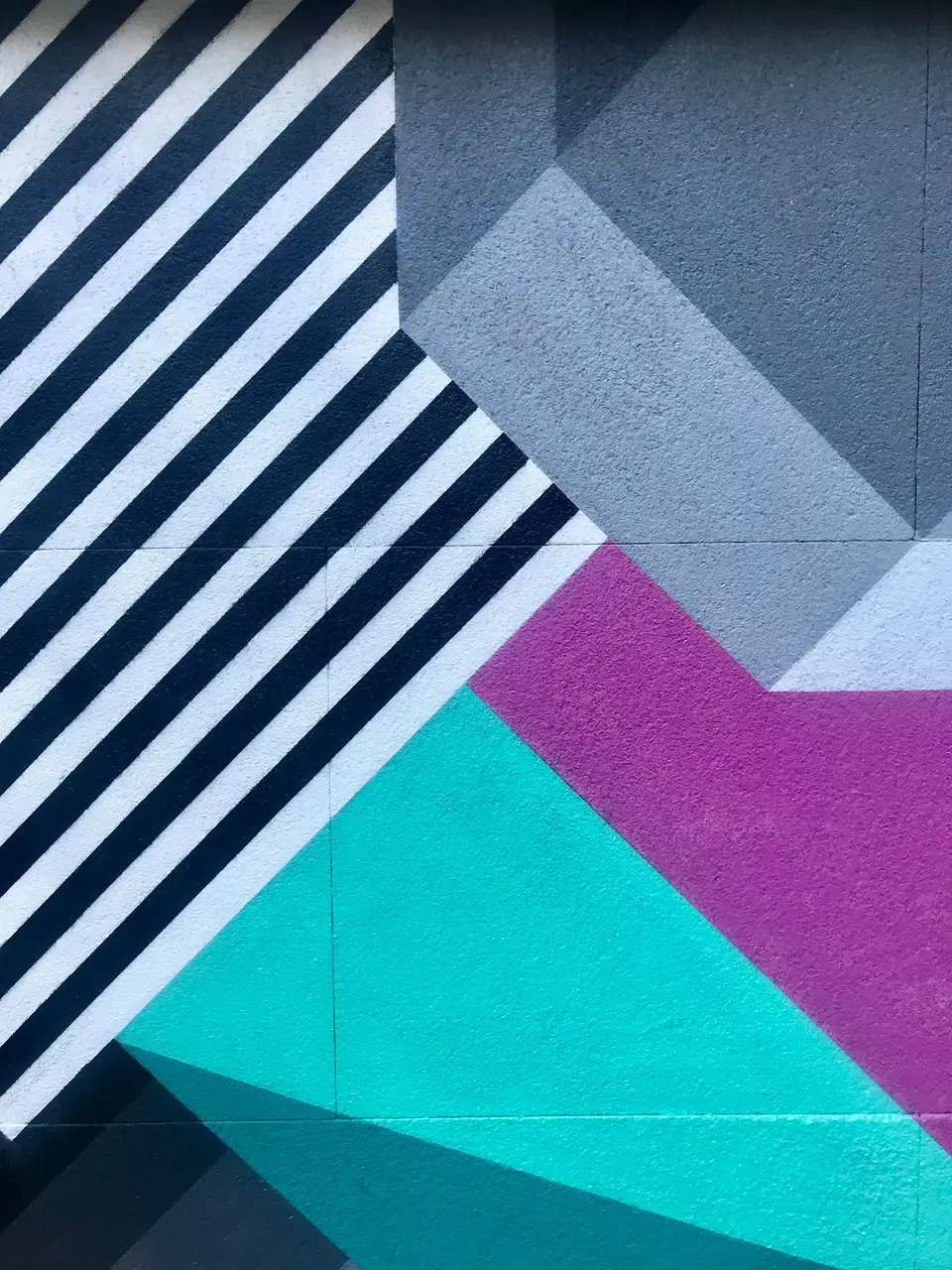 Diagonal stripes cut by teal and violet blocks